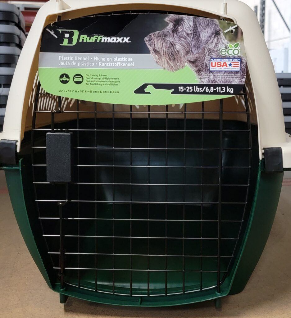 Green and tan plastic dog crate